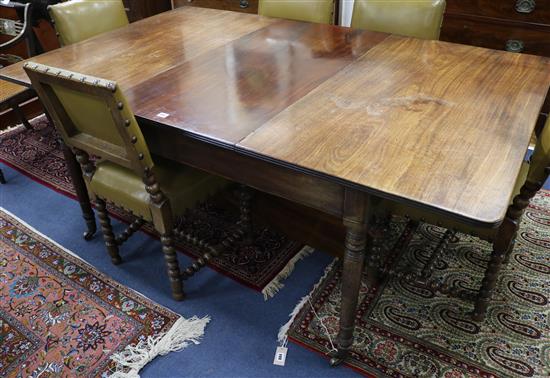 A Georgian mahogany extending dining table with two extra leaves W.183cm